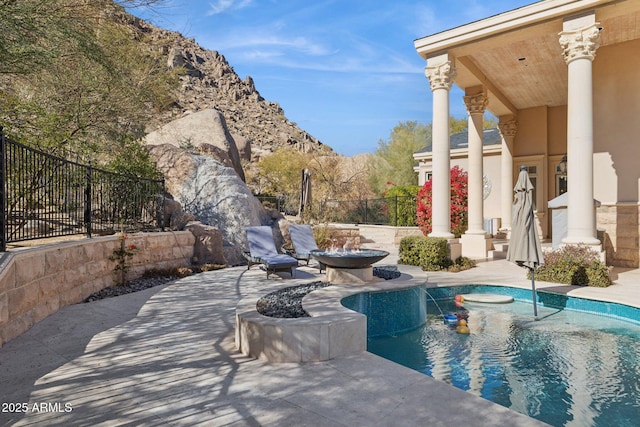 view of swimming pool featuring a mountain view and a patio area