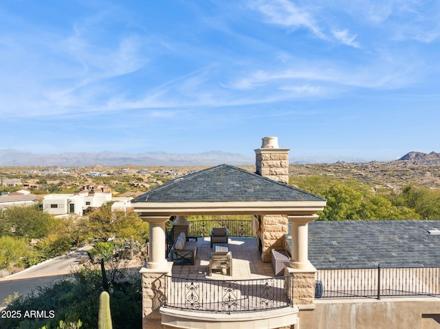 view of home's community featuring a mountain view, a gazebo, and an outdoor hangout area