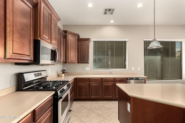 kitchen featuring stainless steel appliances, light countertops, visible vents, and recessed lighting