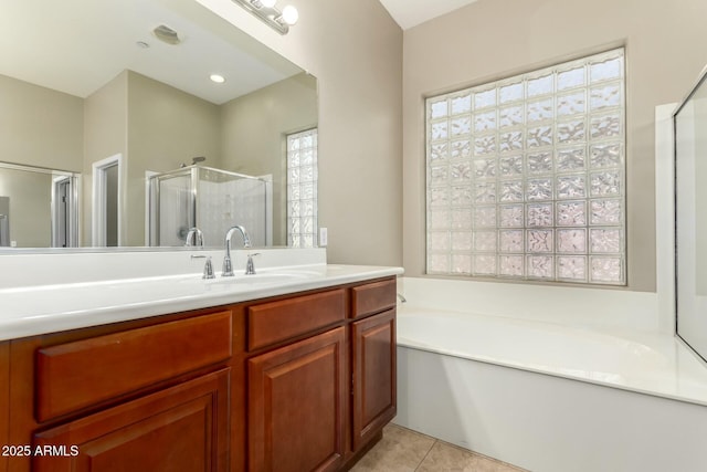 bathroom with tile patterned flooring, a garden tub, vanity, and a shower stall