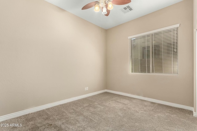 empty room featuring ceiling fan, carpet, visible vents, and baseboards