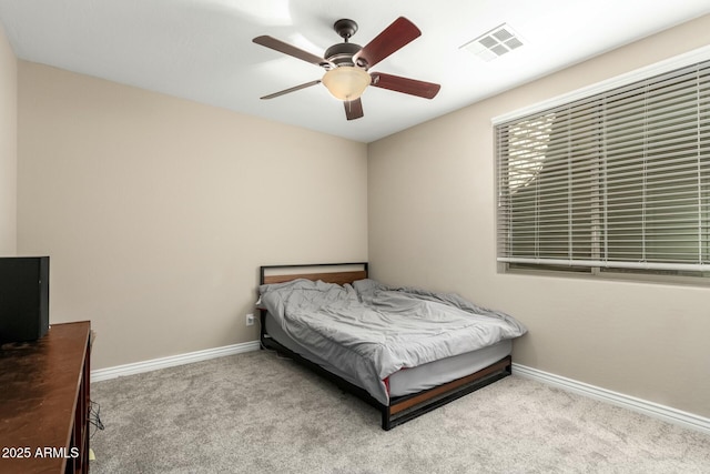 bedroom featuring light carpet, baseboards, visible vents, and ceiling fan