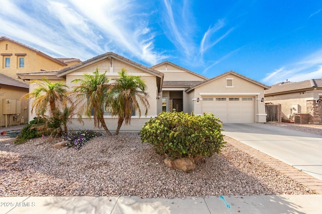 view of front of house featuring driveway, an attached garage, and stucco siding