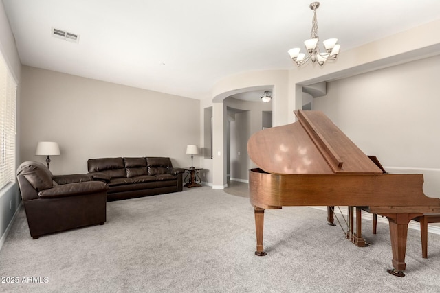 living room featuring arched walkways, a notable chandelier, light colored carpet, visible vents, and baseboards