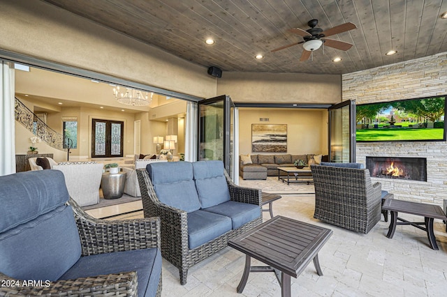 view of patio featuring an outdoor living space with a fireplace, ceiling fan, and french doors