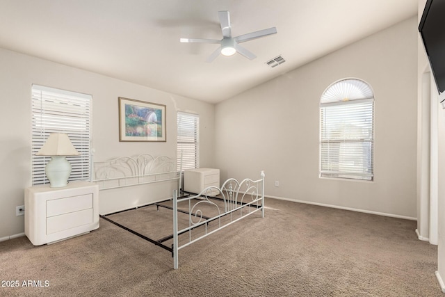 unfurnished bedroom with lofted ceiling, carpet floors, visible vents, and baseboards