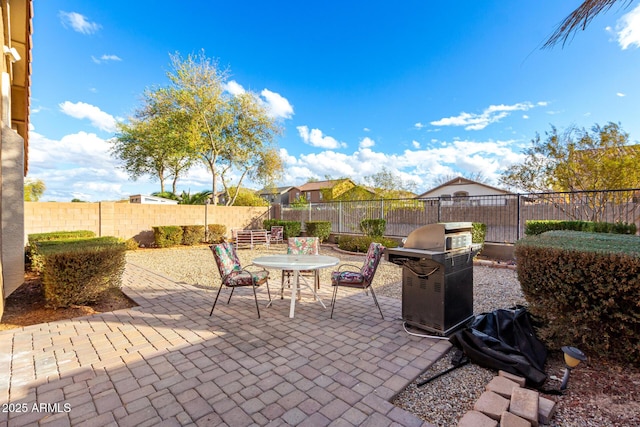 view of patio / terrace featuring outdoor dining area, a fenced backyard, and a grill