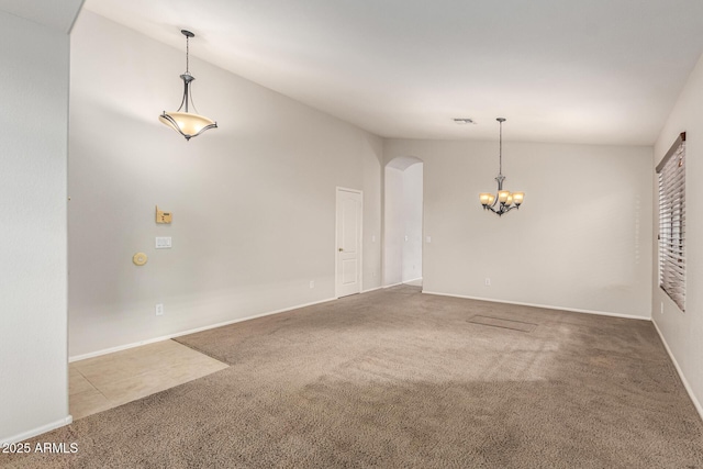 carpeted spare room featuring arched walkways, baseboards, lofted ceiling, and an inviting chandelier