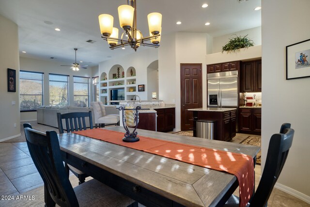 dining room featuring ceiling fan with notable chandelier and light tile patterned floors