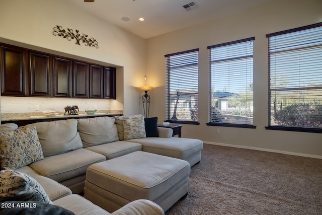 living room with ceiling fan and carpet flooring