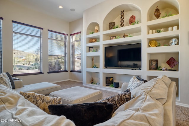 living room featuring built in features, carpet, and a wealth of natural light