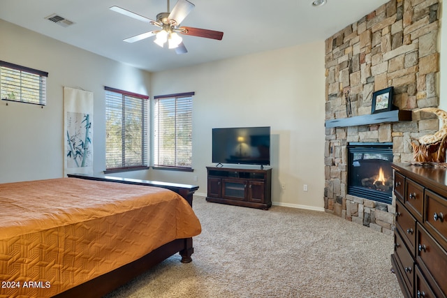 carpeted bedroom featuring ceiling fan, a stone fireplace, and billiards