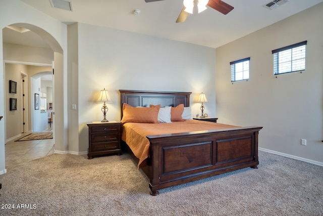 bedroom featuring light carpet and ceiling fan