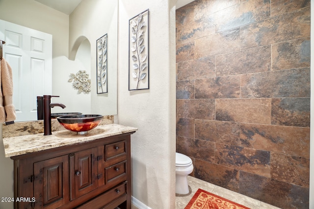 bathroom featuring tile patterned floors, vanity, and toilet