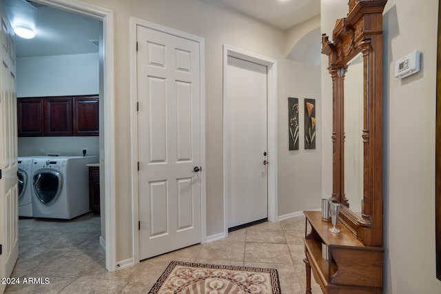 hall with light tile patterned floors and washing machine and clothes dryer