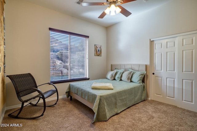 carpeted bedroom with ceiling fan and a closet