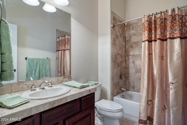 full bathroom featuring vanity, shower / bath combo with shower curtain, toilet, and tile patterned flooring