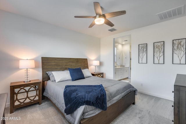 carpeted bedroom with ceiling fan and connected bathroom