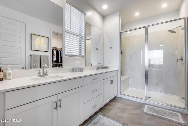 bathroom featuring an enclosed shower and vanity