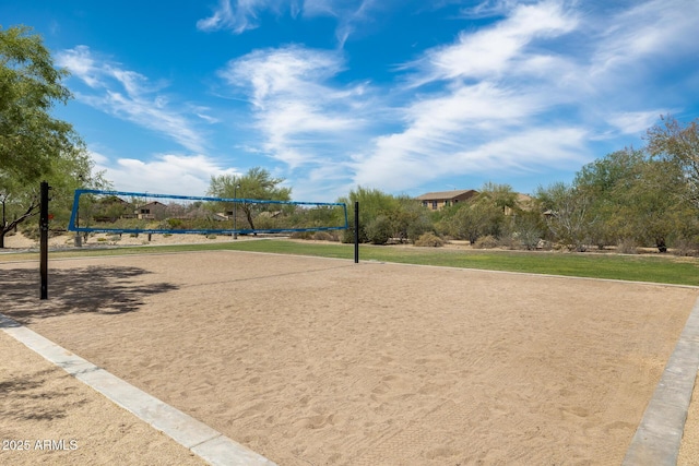 view of community with a lawn and volleyball court