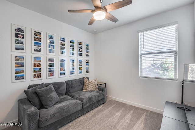 carpeted living room with ceiling fan