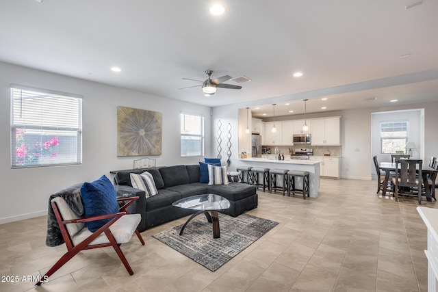 living room featuring ceiling fan and light tile patterned floors