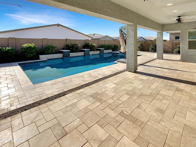 view of swimming pool featuring a patio area and ceiling fan