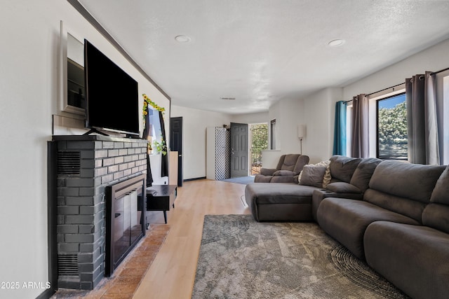 599 W Vah Ki Inn Rd, Coolidge, AZ 85128 - living area featuring a fireplace, light wood-style floors, and recessed lighting