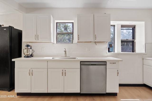 599 W Vah Ki Inn Rd, Coolidge, AZ 85128 - kitchen featuring dishwasher, a sink, freestanding refrigerator, white cabinetry, and light wood-style floors