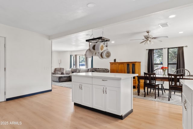 599 W Vah Ki Inn Rd, Coolidge, AZ 85128 - kitchen with light wood-style flooring, light countertops, white cabinetry, recessed lighting, and a center island