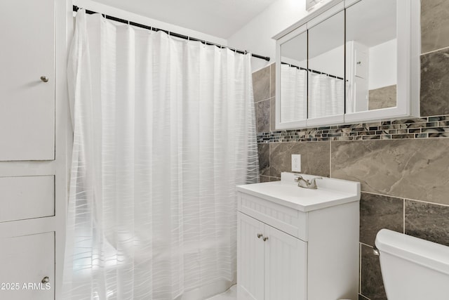 599 W Vah Ki Inn Rd, Coolidge, AZ 85128 - bathroom with tile walls, toilet, and vanity