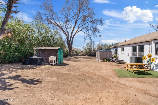 599 W Vah Ki Inn Rd, Coolidge, AZ 85128 - view of yard with a shed, an outdoor structure, and central AC unit