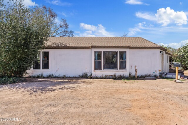 599 W Vah Ki Inn Rd, Coolidge, AZ 85128 - view of side of property featuring stucco siding and a shingled roof