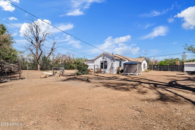 599 W Vah Ki Inn Rd, Coolidge, AZ 85128 - view of yard with fence, an outdoor structure, and a storage unit