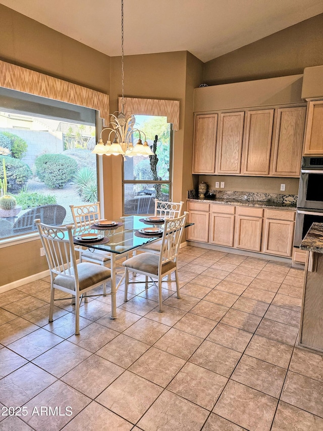 dining area featuring plenty of natural light, light tile patterned floors, a notable chandelier, and vaulted ceiling