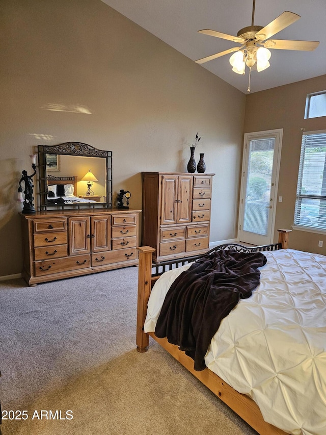 bedroom featuring ceiling fan, light colored carpet, and vaulted ceiling