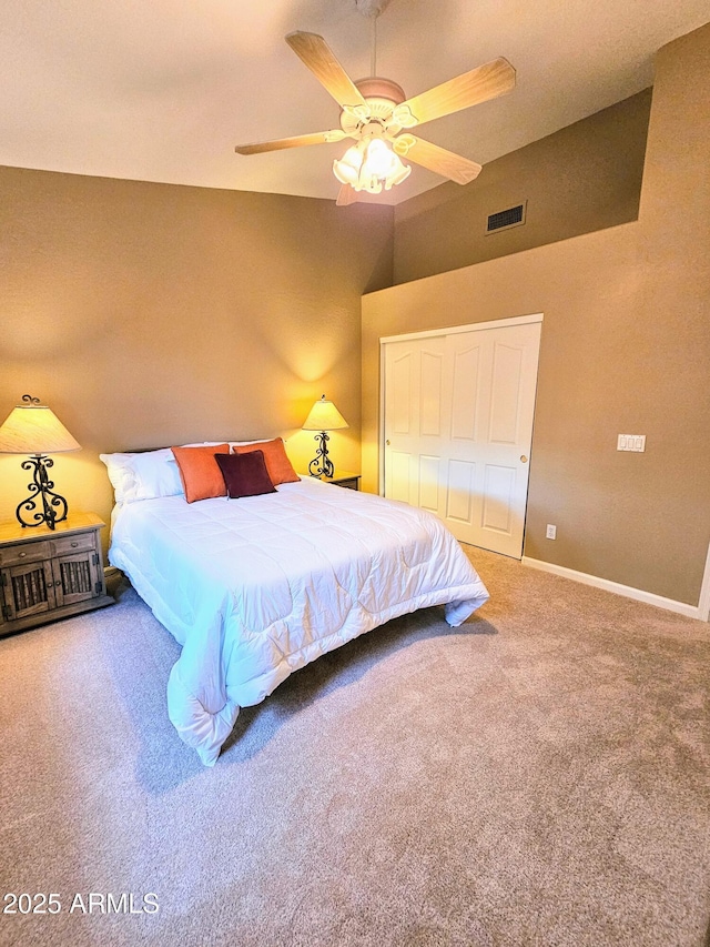 carpeted bedroom with ceiling fan, a closet, and lofted ceiling