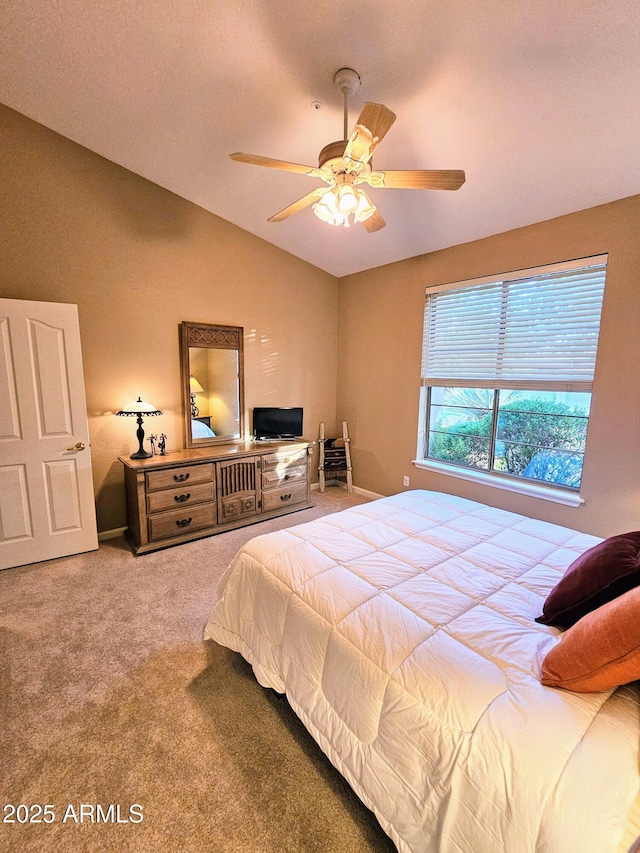 carpeted bedroom featuring ceiling fan and vaulted ceiling