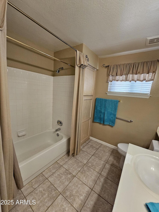 full bathroom featuring toilet, tile patterned flooring, shower / bathtub combination with curtain, a textured ceiling, and sink