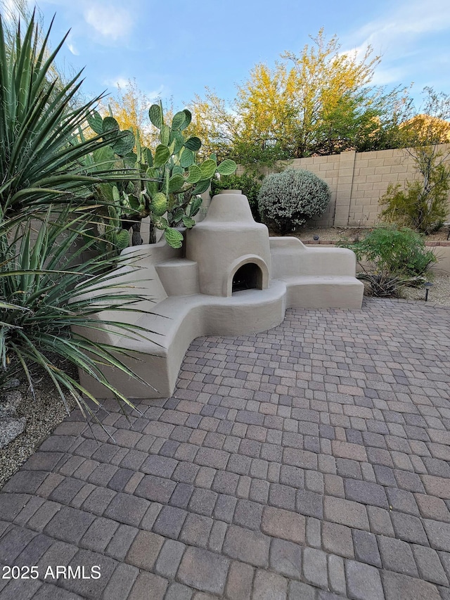 view of patio featuring an outdoor fireplace