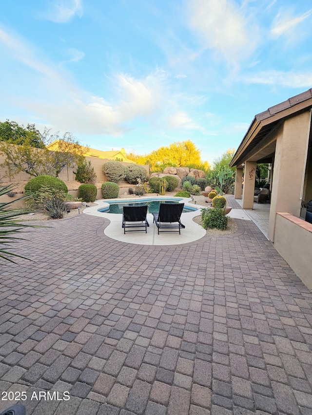 view of patio with a fenced in pool