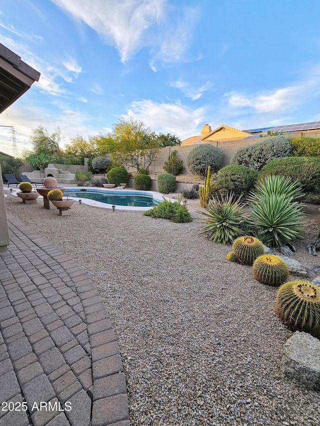 exterior space featuring a patio and a fenced in pool