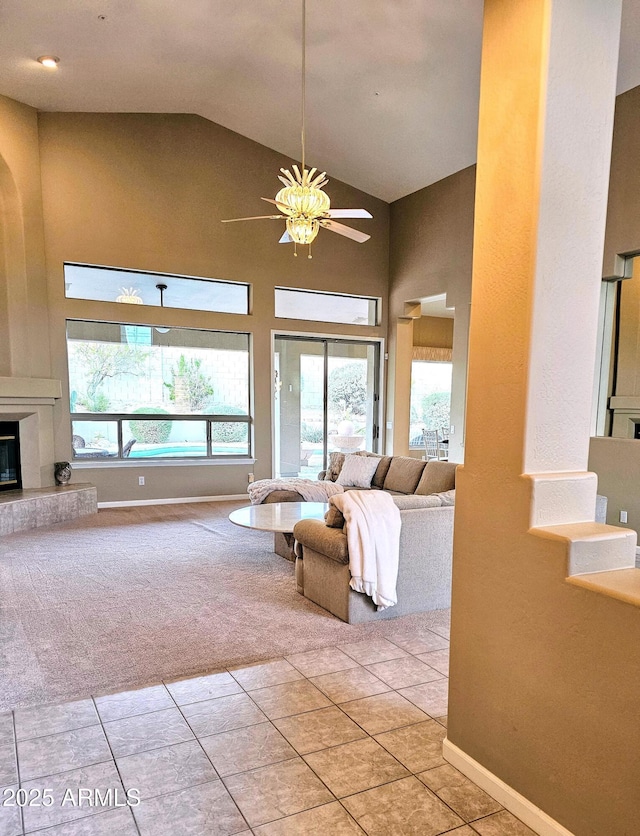 living room with ceiling fan, light tile patterned floors, and high vaulted ceiling