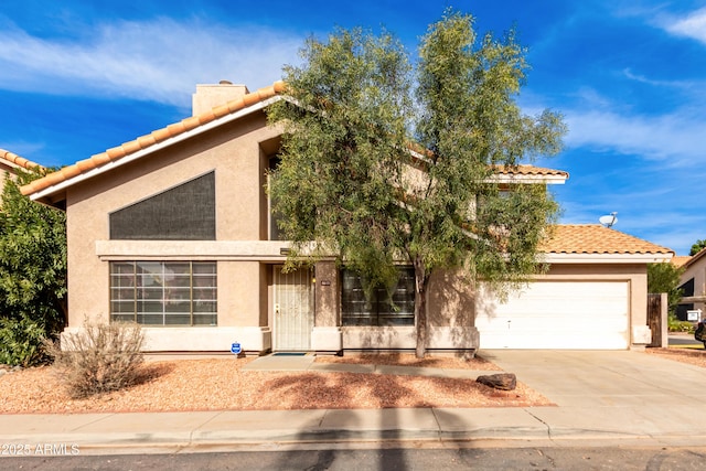 mediterranean / spanish home with a garage