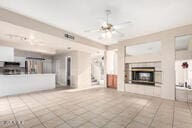 unfurnished living room featuring ceiling fan