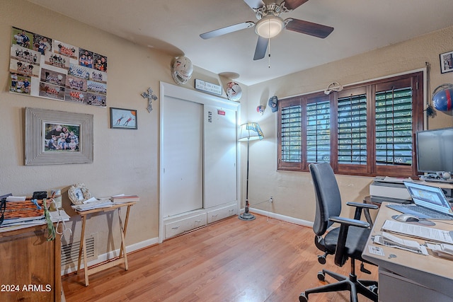 office space featuring baseboards, ceiling fan, and wood finished floors