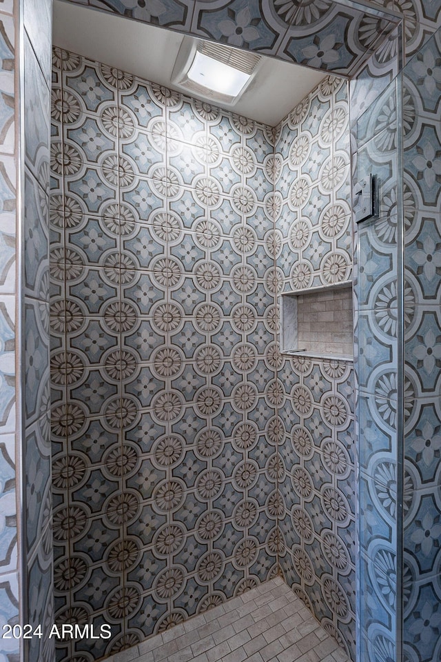 full bathroom with a tile shower