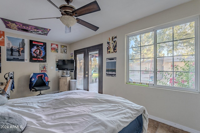 bedroom with baseboards, multiple windows, and access to outside