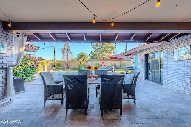 view of patio / terrace with outdoor dining space, a fenced in pool, and area for grilling