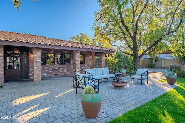 view of patio / terrace featuring an outdoor living space with a fire pit and fence